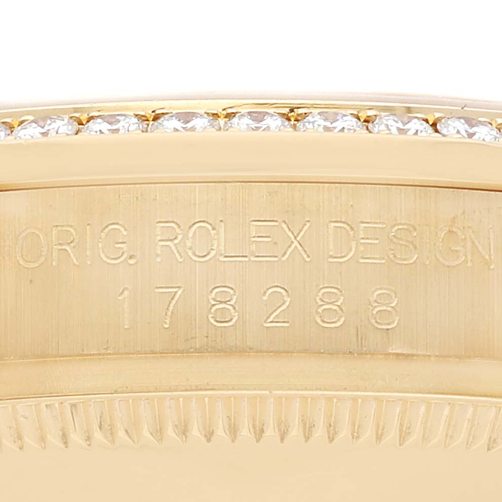 This image shows a close-up of the serial number and bejeweled bezel on a Rolex President 178288 Women
s Yellow Gold Champagne Dial 178288 Women
s Yellow Gold Champagne Dial model watch.