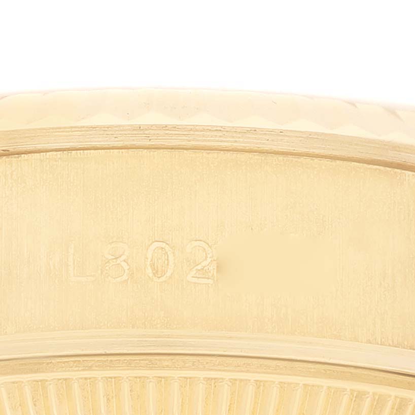 This is a close-up of the caseback edge of the Rolex President 69178G Women's Yellow Gold Champagne Dial 69178G Women's Yellow Gold Champagne Dial model, showing part of the serial number.