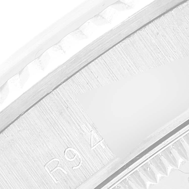 This image shows a close-up of the serial number engraving on the bezel of a Rolex President 68279 Women's White Gold Black Dial 68279 Women's White Gold Black Dial model watch.