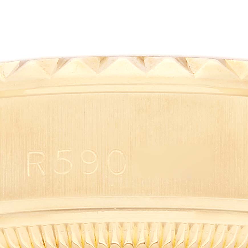 This close-up image shows the engraved serial number and part of the bezel on a Rolex President 69188 Women
s Yellow Gold Champagne Dial 69188 Women
s Yellow Gold Champagne Dial model watch.