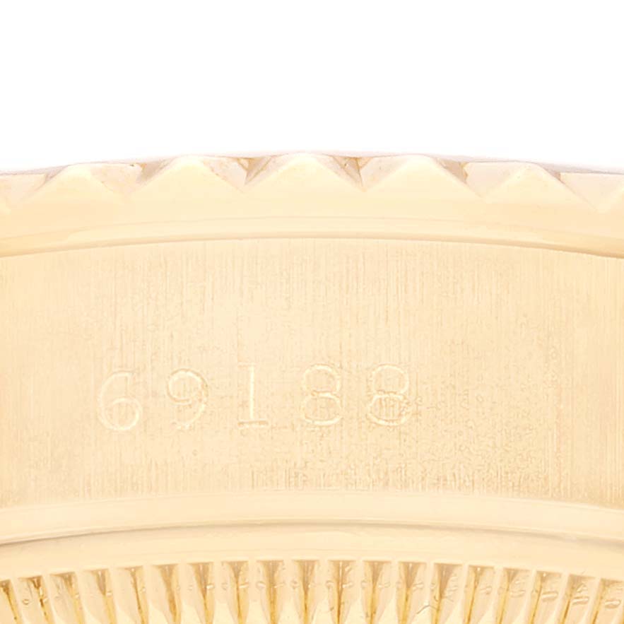 The image shows a close-up view of the case side and bezel of a Rolex President 69188 Women
s Yellow Gold Champagne Dial 69188 Women
s Yellow Gold Champagne Dial model watch, with the engraved serial number visible.