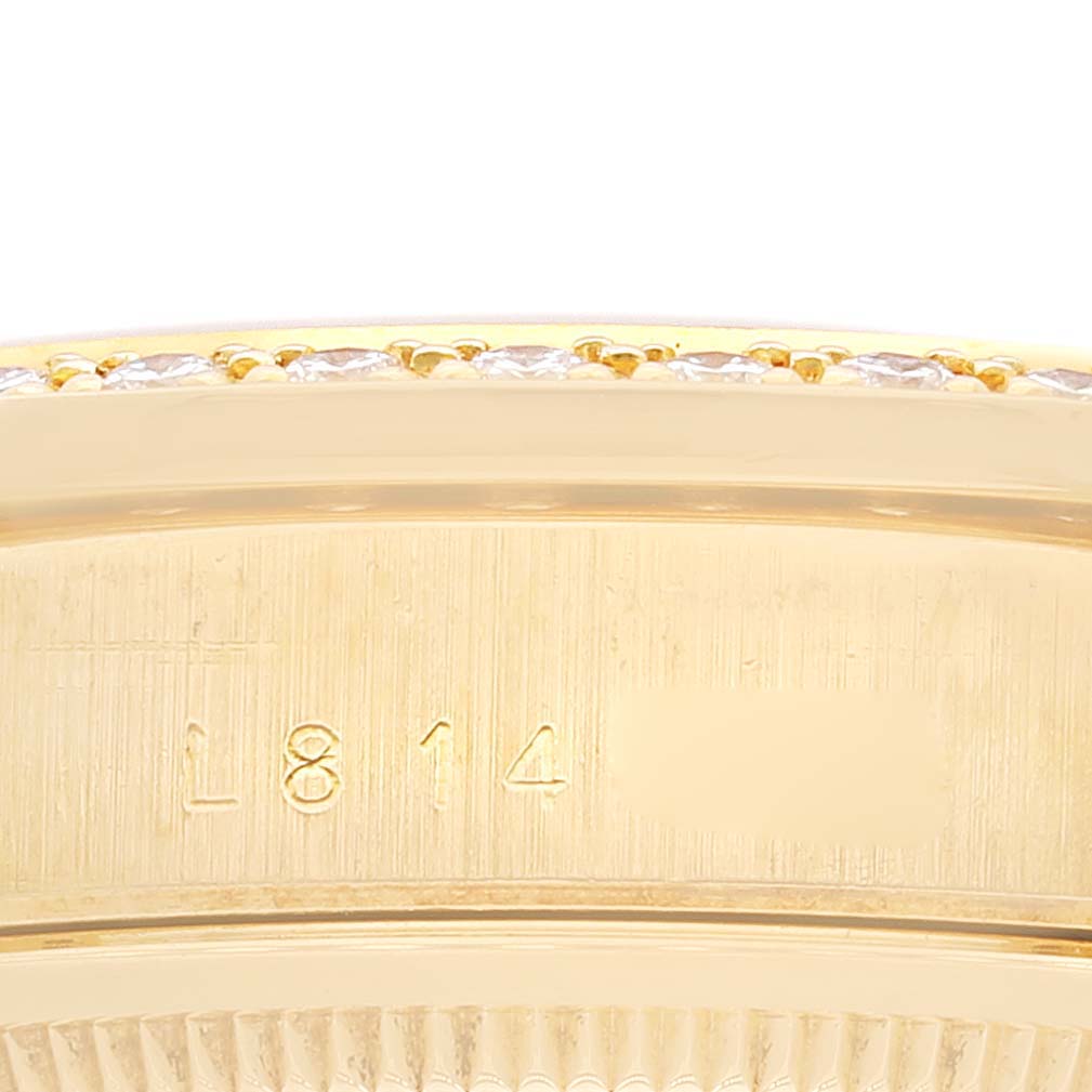 This close-up image of a Rolex President 18348 Men
s Yellow Gold Champagne Dial 18348 Men
s Yellow Gold Champagne Dial watch showcases its side case with engraved markings and part of its diamond-encrusted bezel.