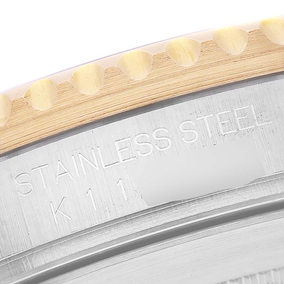 This image shows a close-up of the bezel and stainless steel case back band of a Rolex Submariner 16613 Men's Steel and Gold (two tone) Blue Dial 16613 Men's Steel and Gold (two tone) Blue Dial watch.