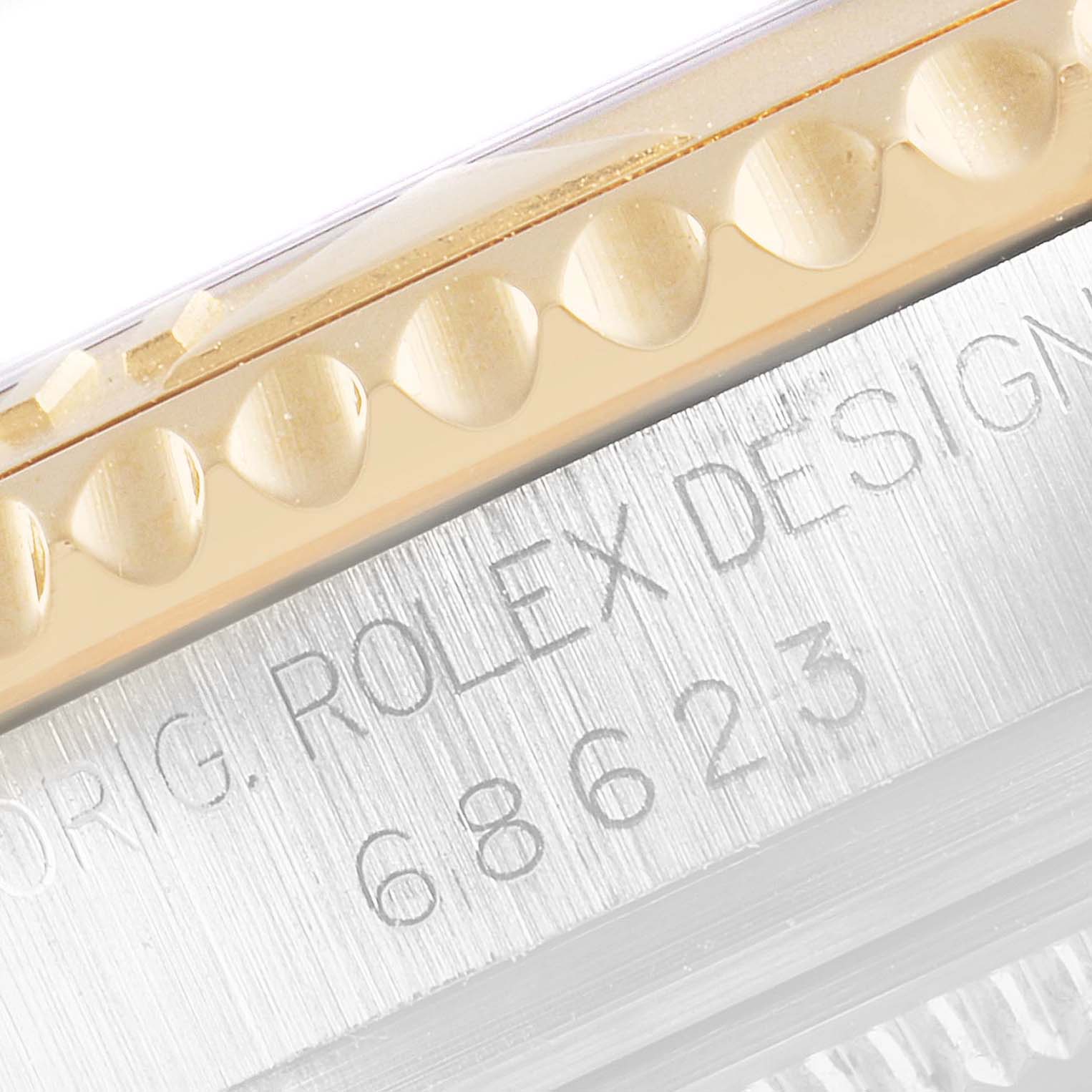 This image shows a close-up of the engraved bezel and model number on the case side of a Rolex Yacht-Master 68623 Men's Steel and Gold (two tone) White Dial 68623 Men's Steel and Gold (two tone) White Dial watch.