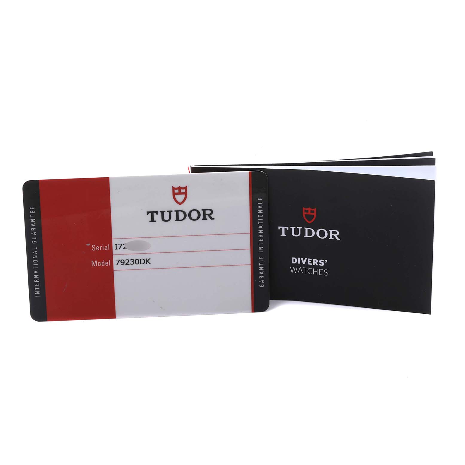 The image shows the international guarantee card and booklet for the Tudor Heritage Black Bay 79230DK Men
s Stainless Steel Black Dial 79230DK Men
s Stainless Steel Black Dial model.