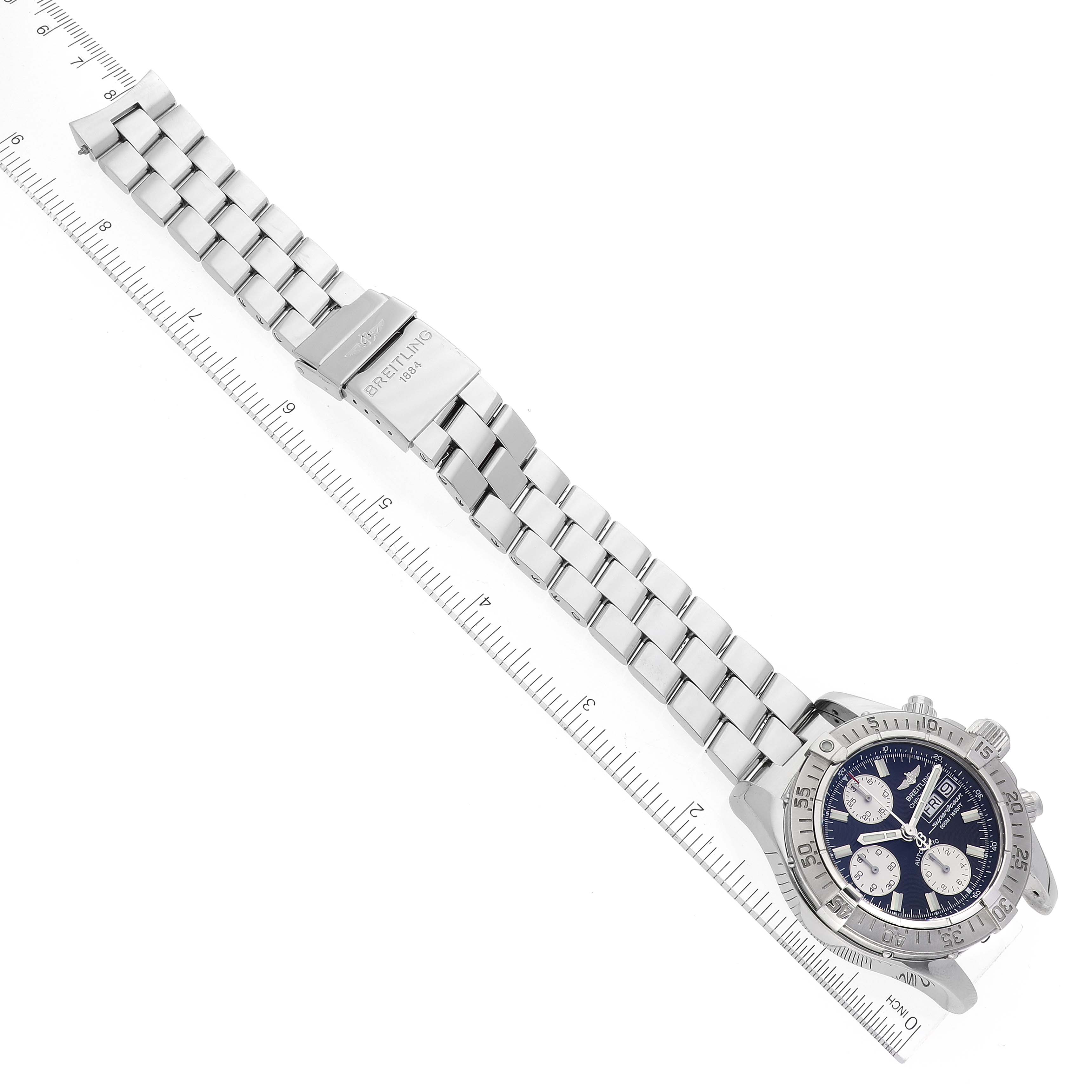 The Superocean model by Breitling is shown from a top view, displaying the face, bezel, chronograph buttons, and stainless steel bracelet.