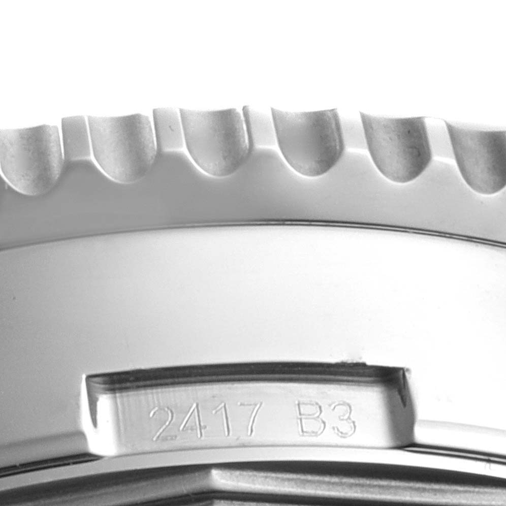 Close-up of the bezel and case of a Breitling Navitimer AB0127-211-B1A1 Men
s Stainless Steel Black Dial AB0127-211-B1A1 Men
s Stainless Steel Black Dial, showing the serial number and part of the grooved edge.