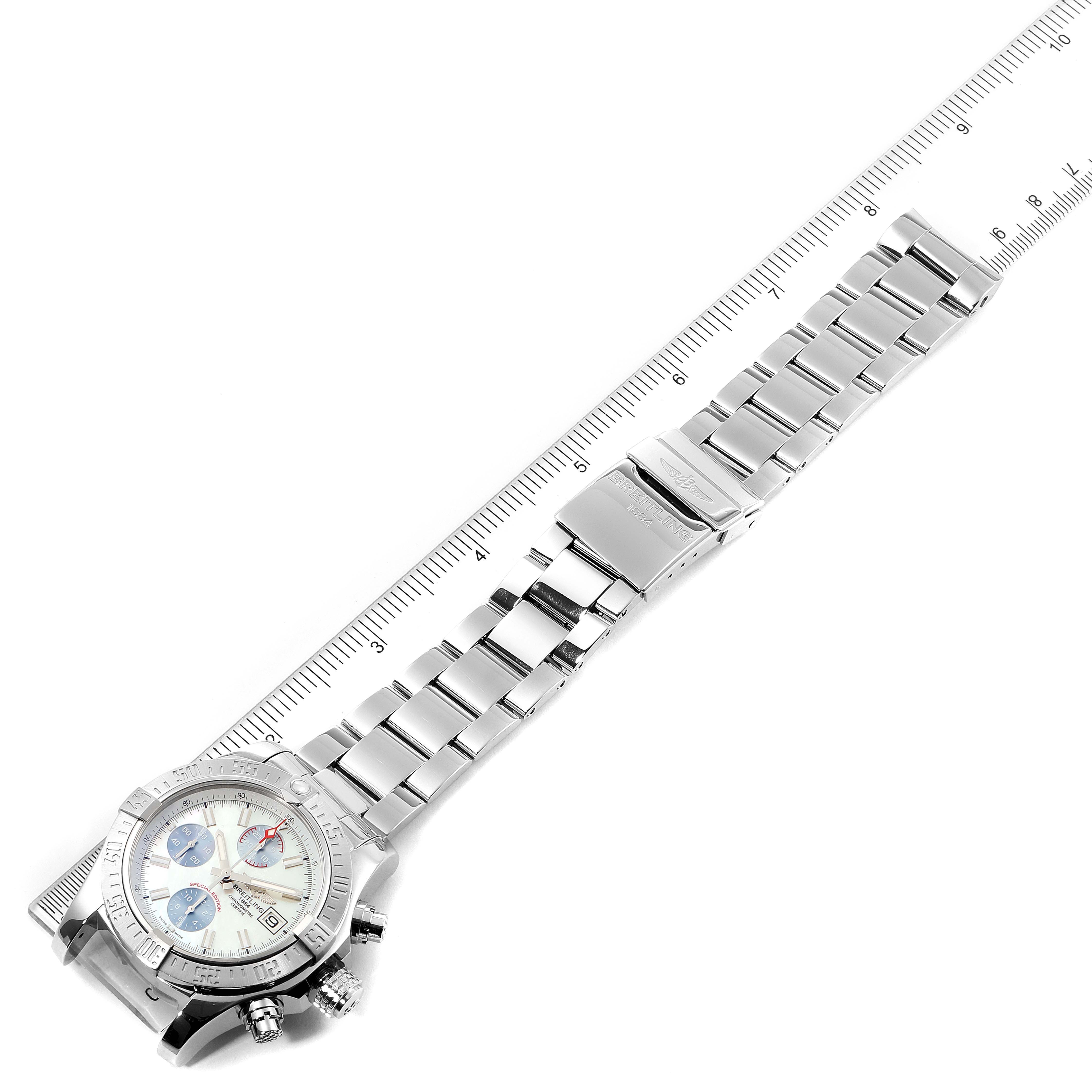 The image shows a Breitling Avenger A13381 Men's Stainless Steel Mother of Pearl Dial A13381 Men's Stainless Steel Mother of Pearl Dial watch at an overhead angle, displaying its face, bracelet, and clasp alongside a ruler.