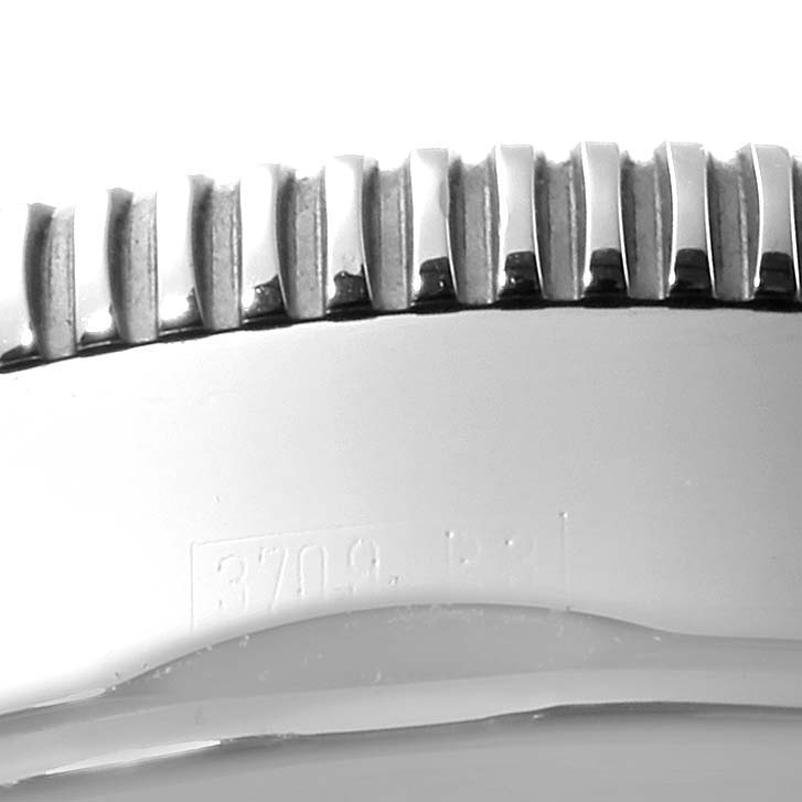 The image shows a close-up of the bezel and part of the case of a Breitling Superocean A23320 Men
s Stainless Steel Silver Dial A23320 Men
s Stainless Steel Silver Dial watch.