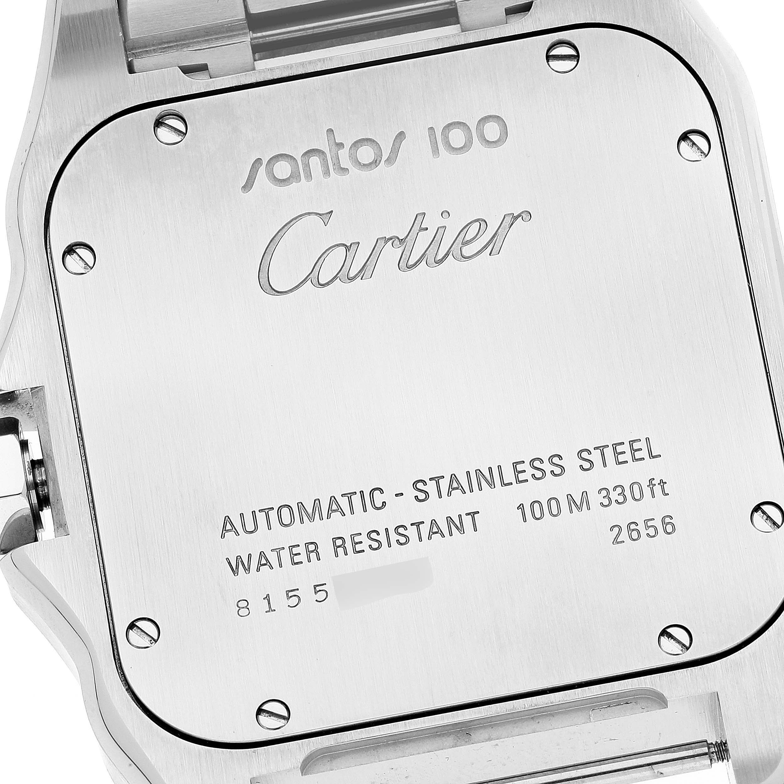 The image shows the back case of a Santos 100 model by Cartier, highlighting its engraving and specifications.