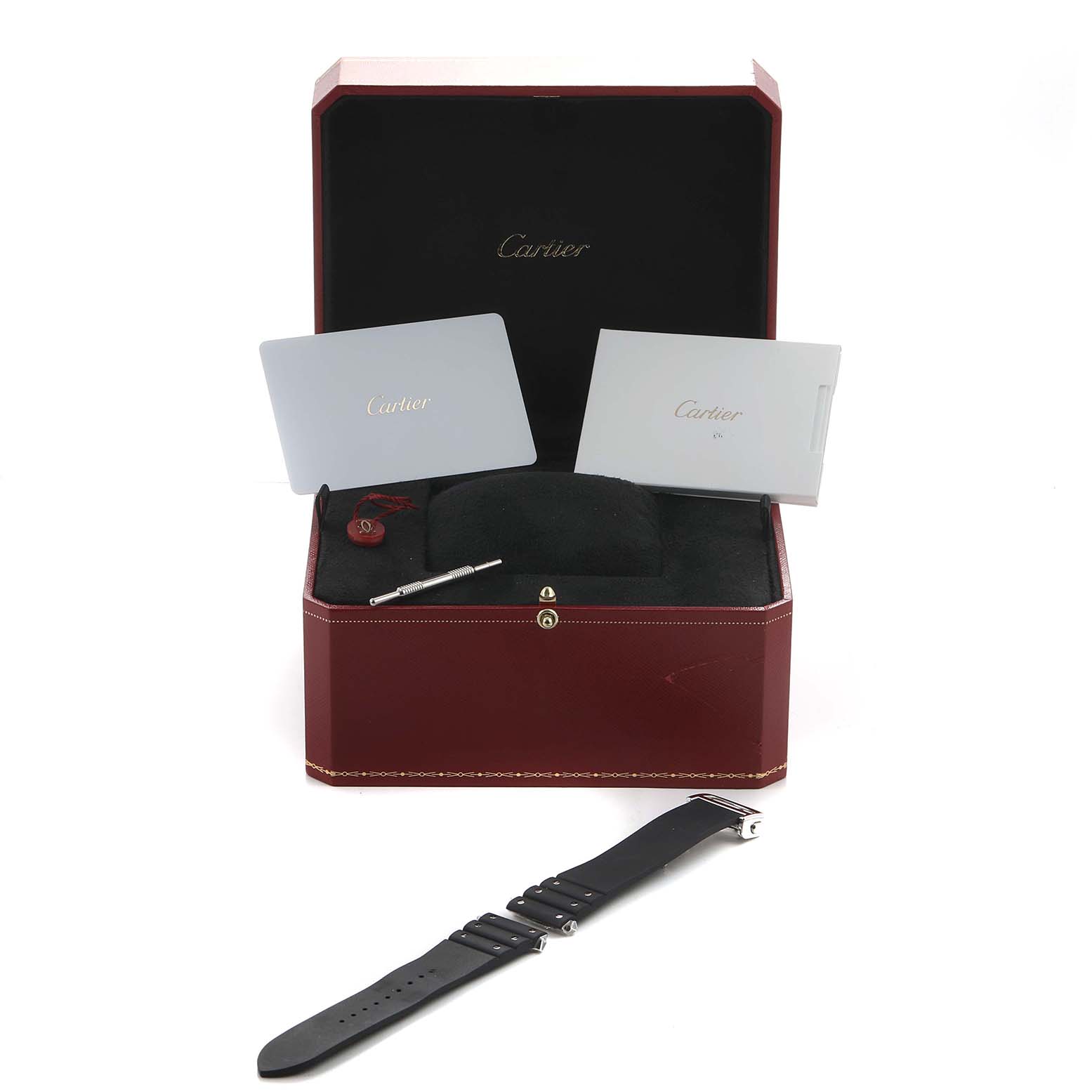 The image shows a Cartier Santos WSSA0037 Men's Stainless Steel Grey Dial watch box with accessories, including a black strap, tool, and booklets, viewed from above.