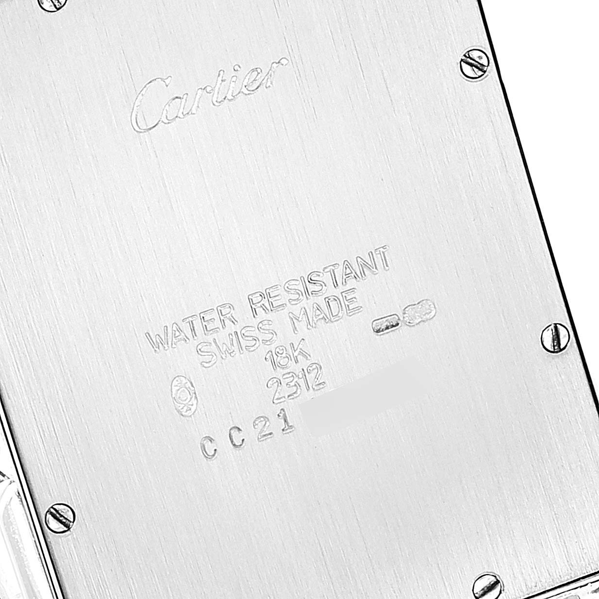 This is the back view of a Cartier Tank Americaine W26033L1 Men's White Gold Silver Dial W26033L1 Men's White Gold Silver Dial watch, displaying engravings and screws.