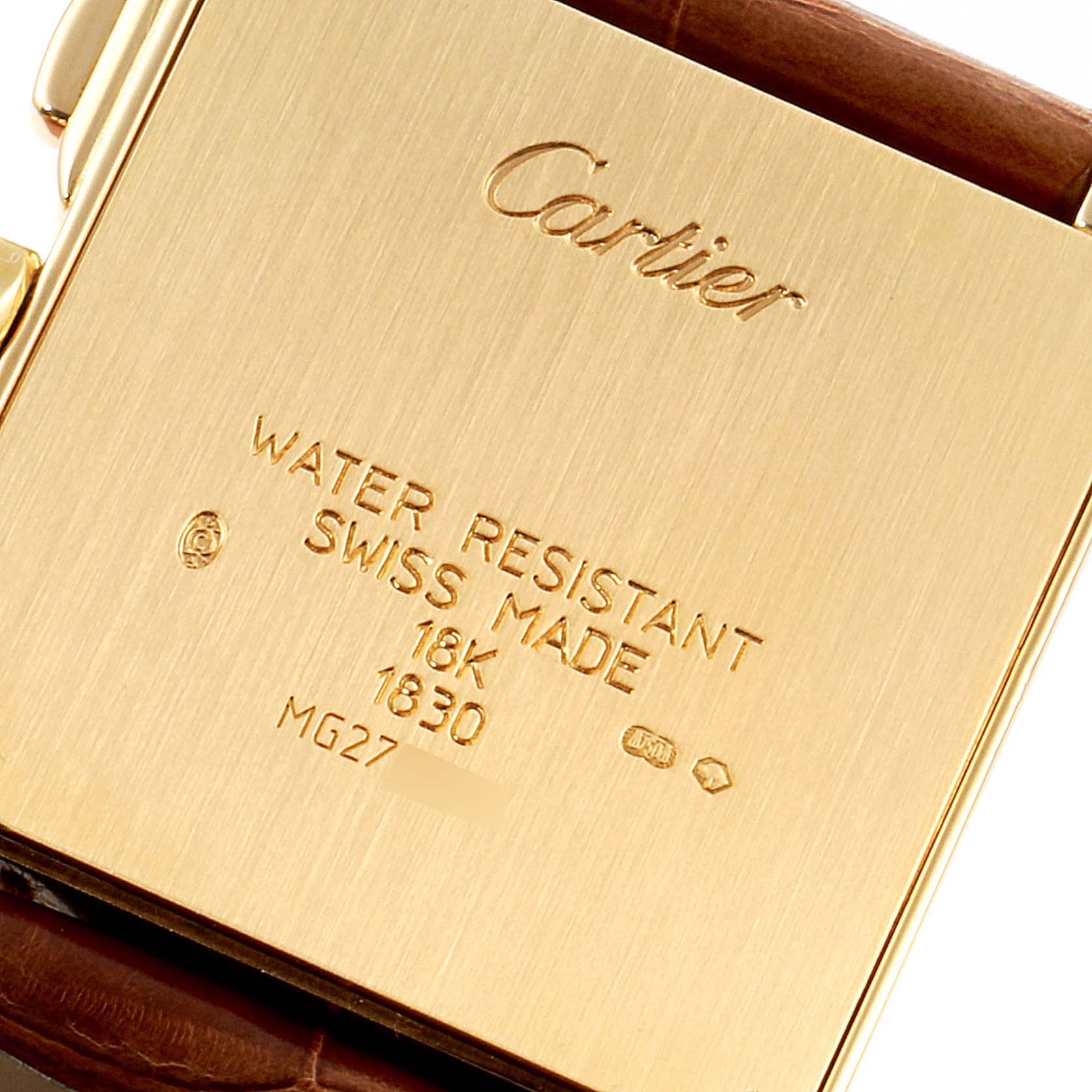 The image shows the engraved back case of a Cartier Tank Française watch, featuring details like water resistance and material.