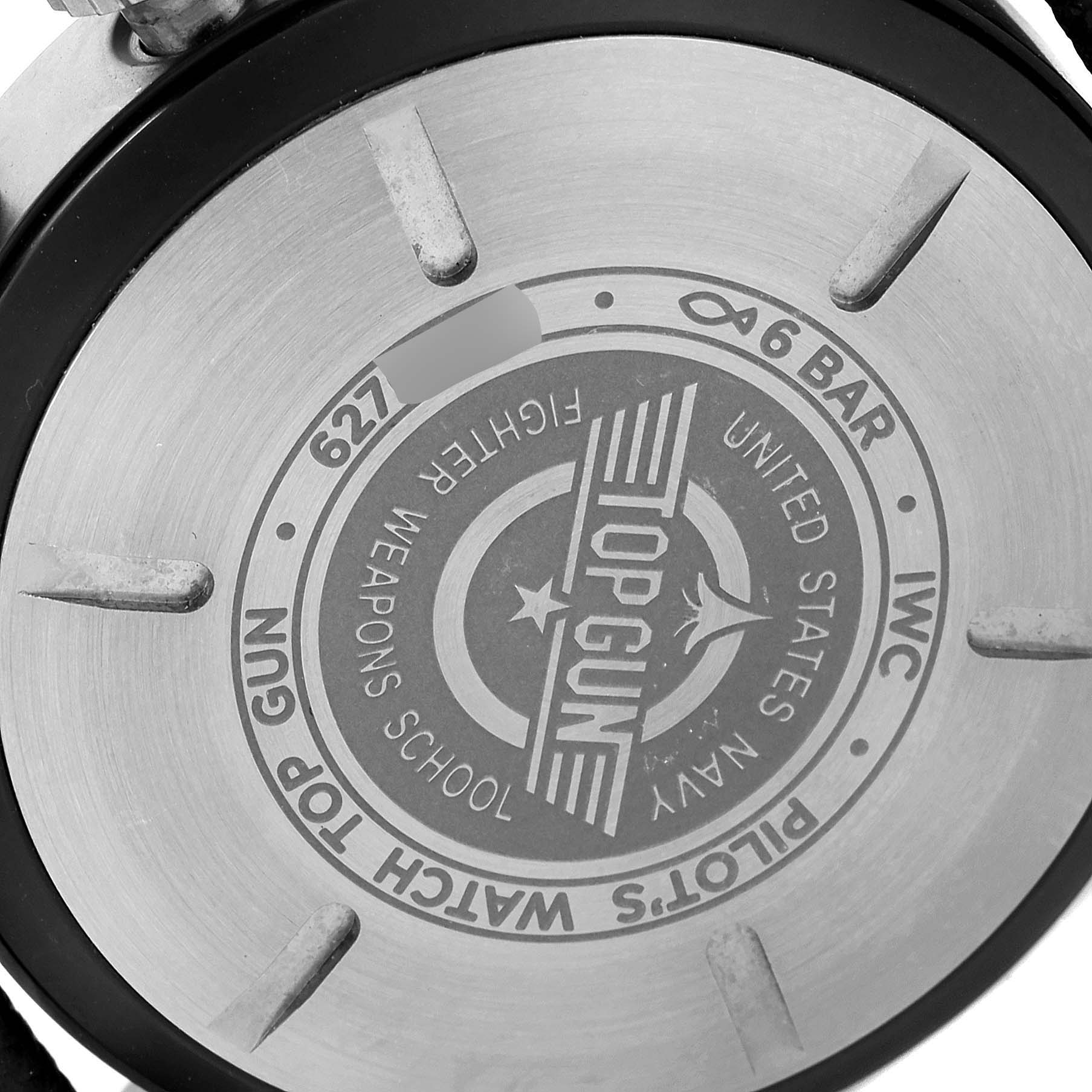 The image shows the back case of an IWC Pilot IW389101 Men's Ceramic Black Dial IW389101 Men's Ceramic Black Dial "TOP GUN" watch, featuring engraved branding and specifications.