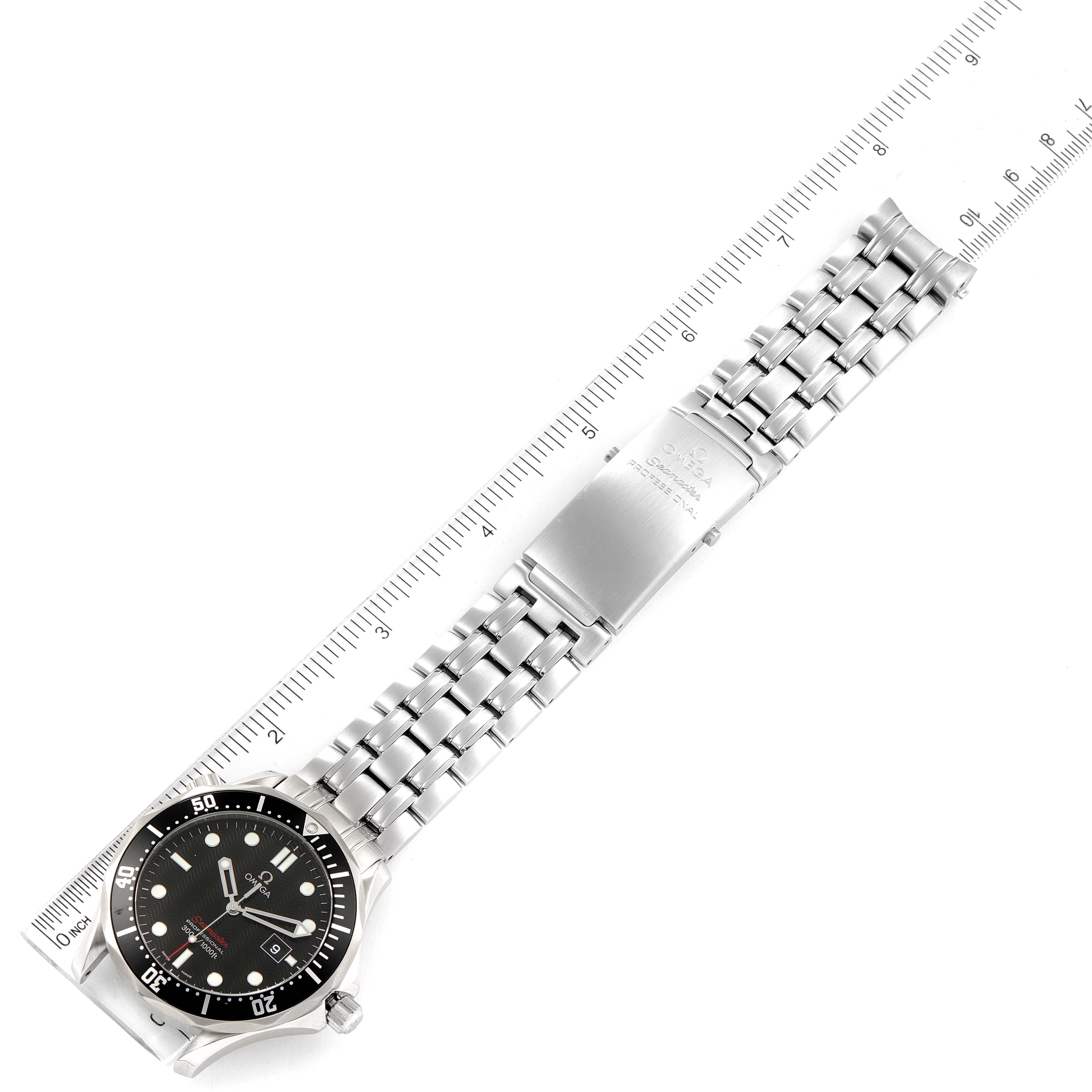 The Omega Seamaster 212.30.41.61.01.001 Men's Stainless Steel Black Dial 212.30.41.61.01.001 Men's Stainless Steel Black Dial watch is shown from a top-down angle, displaying the face, bezel, and metal bracelet with a ruler for scale.