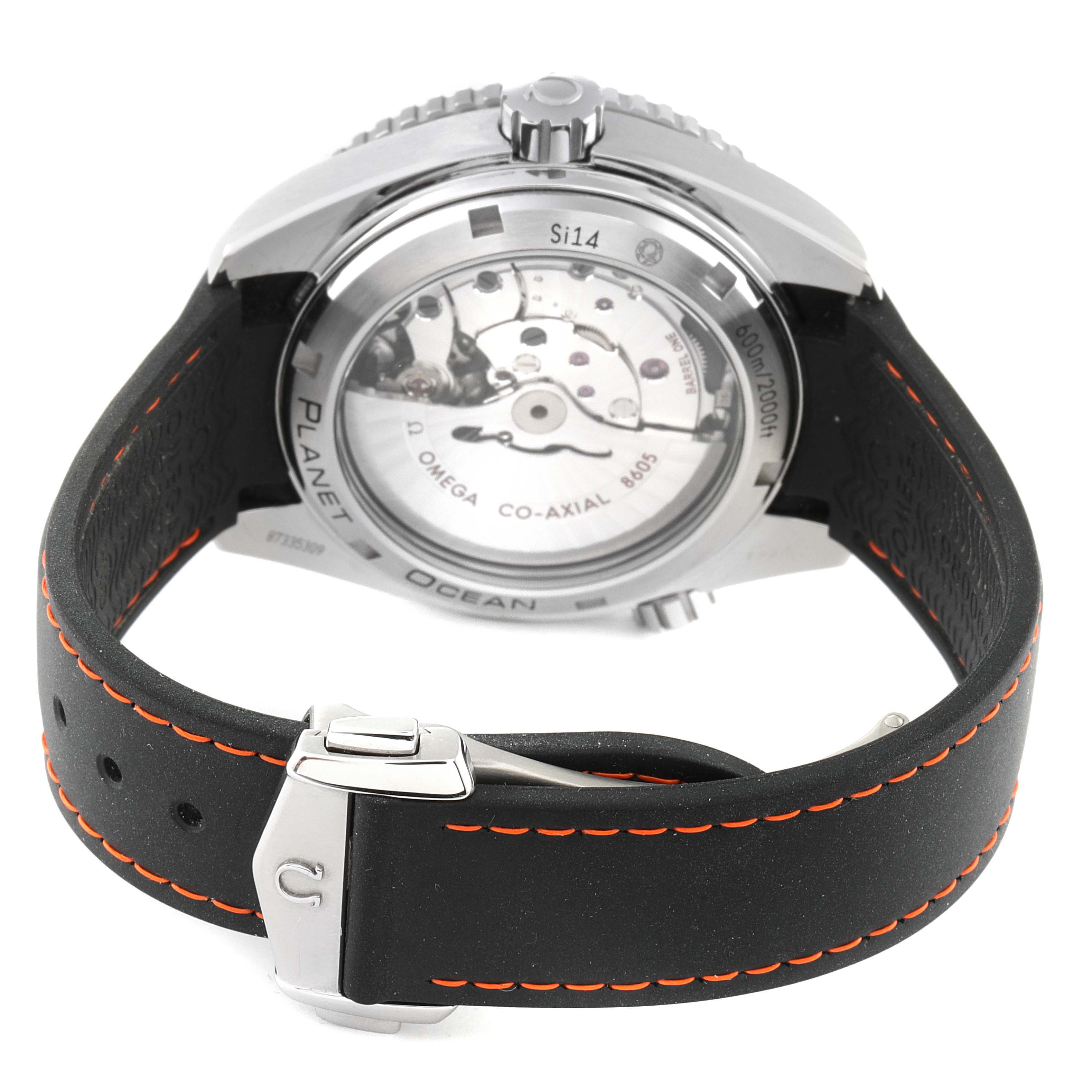 The image shows the back view of an Omega Planet Ocean 232.32.44.22.01.002 Men's Stainless Steel Black Dial 232.32.44.22.01.002 Men's Stainless Steel Black Dial watch, highlighting the movement and the strap clasp.