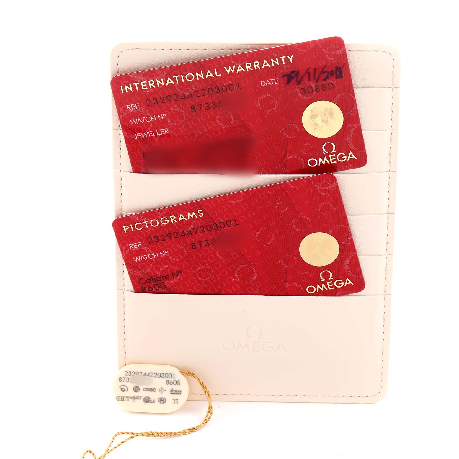 The image shows Omega Seamaster 232.92.44.22.03.001 Men's Titanium Blue Dial watch accessories, including warranty and pictogram cards, displayed in a holder.