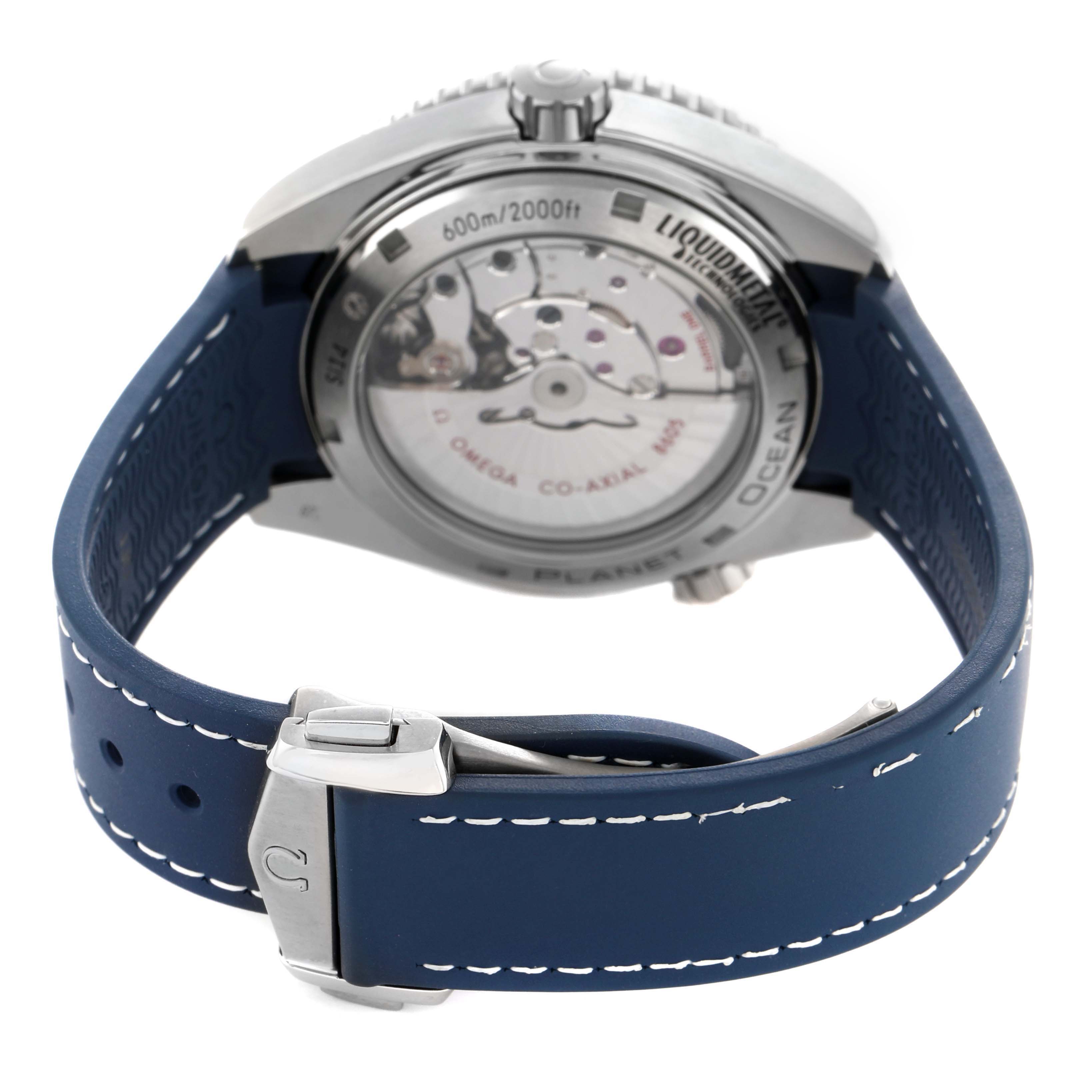 The Omega Seamaster 232.92.44.22.03.001 Men's Titanium Blue Dial model is shown from the rear, highlighting the transparent case back and blue strap with a clasp.