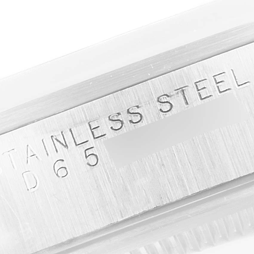 The image shows a close-up of the "STAINLESS STEEL" engraving on the case of a Rolex Air-King 14000M Men's Stainless Steel Blue Dial 14000M Men's Stainless Steel Blue Dial watch.