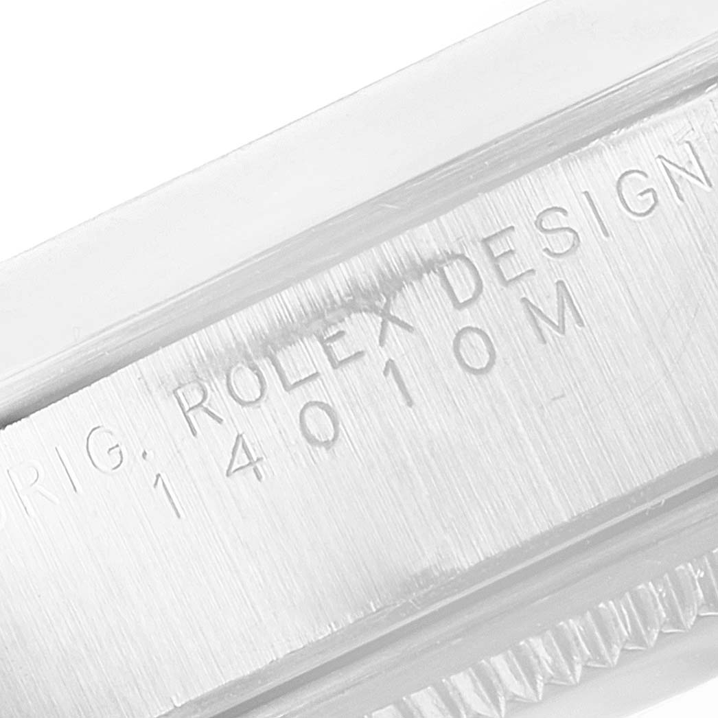 This image shows a close-up angle of the engraved serial number on the side of a Rolex Air-King 14010M Men's Stainless Steel White Dial 14010M Men's Stainless Steel White Dial watch case.