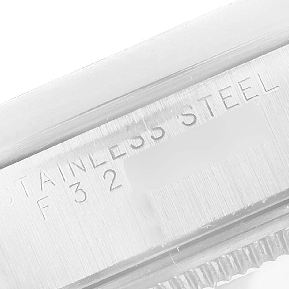 This close-up image shows the engraved stainless steel band of a Rolex Air-King 14010M Men's Stainless Steel White Dial 14010M Men's Stainless Steel White Dial model watch.