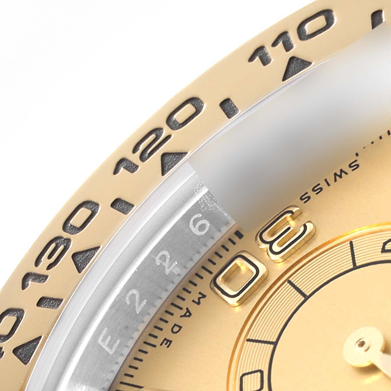 This close-up image of the Rolex Daytona 116503 Men's Steel and Gold (two tone) Champagne Dial 116503 Men's Steel and Gold (two tone) Champagne Dial watch shows the tachymeter bezel and part of the dial at an angled view.