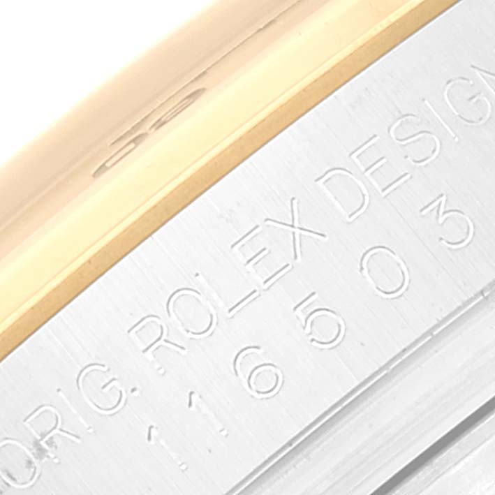 This close-up image shows the engraved side of the bezel on a Rolex Daytona 116503 Men's Steel and Gold (two tone) Champagne Dial 116503 Men's Steel and Gold (two tone) Champagne Dial watch, featuring the model number and design details.