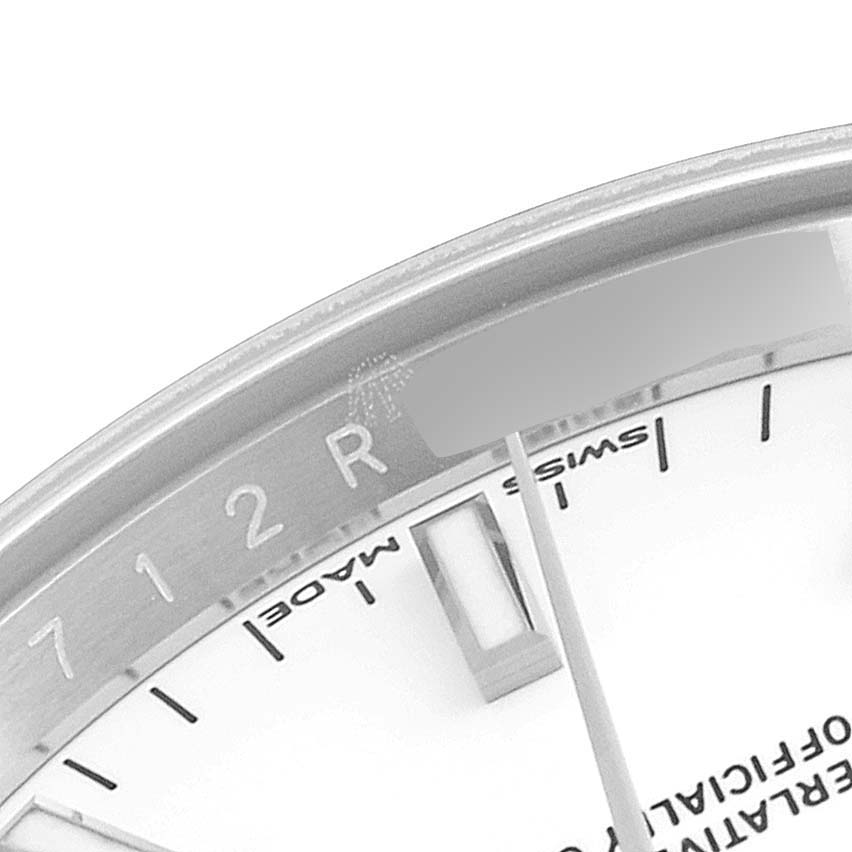 The image shows a close-up of the dial and part of the bezel of a Rolex Date 115200 Men's Stainless Steel White Dial 115200 Men's Stainless Steel White Dial watch model.