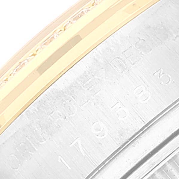 The image shows a close-up of the side of the Rolex Datejust 179383 Women's Steel and Gold (two tone) Champagne Dial 179383 Women's Steel and Gold (two tone) Champagne Dial watch, specifically the engraved edge of the bezel.