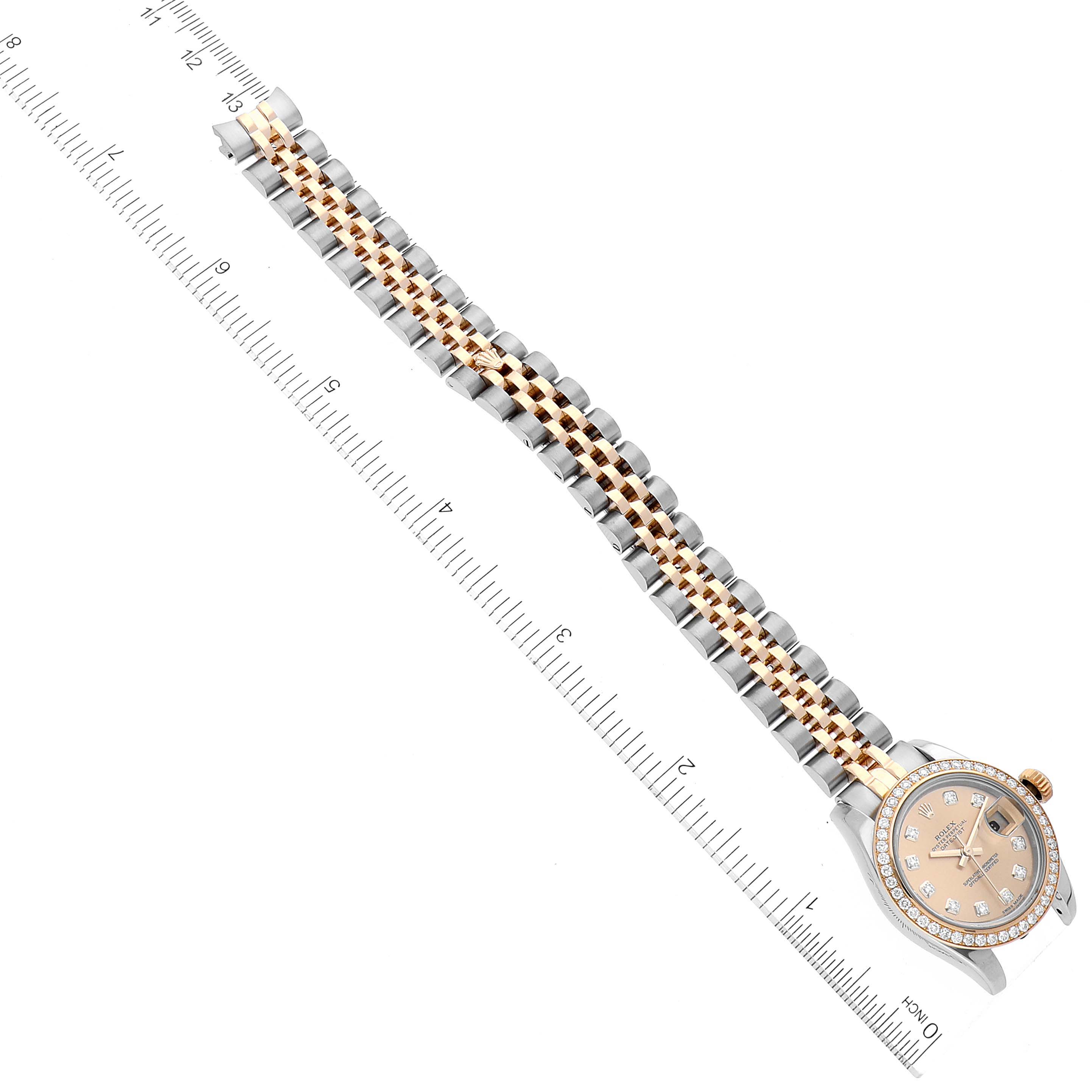 The image shows a Rolex Datejust 179383 Women's Steel and Gold (two tone) Champagne Dial 179383 Women's Steel and Gold (two tone) Champagne Dial watch placed flat with its face and bracelet visible, alongside a measuring ruler.