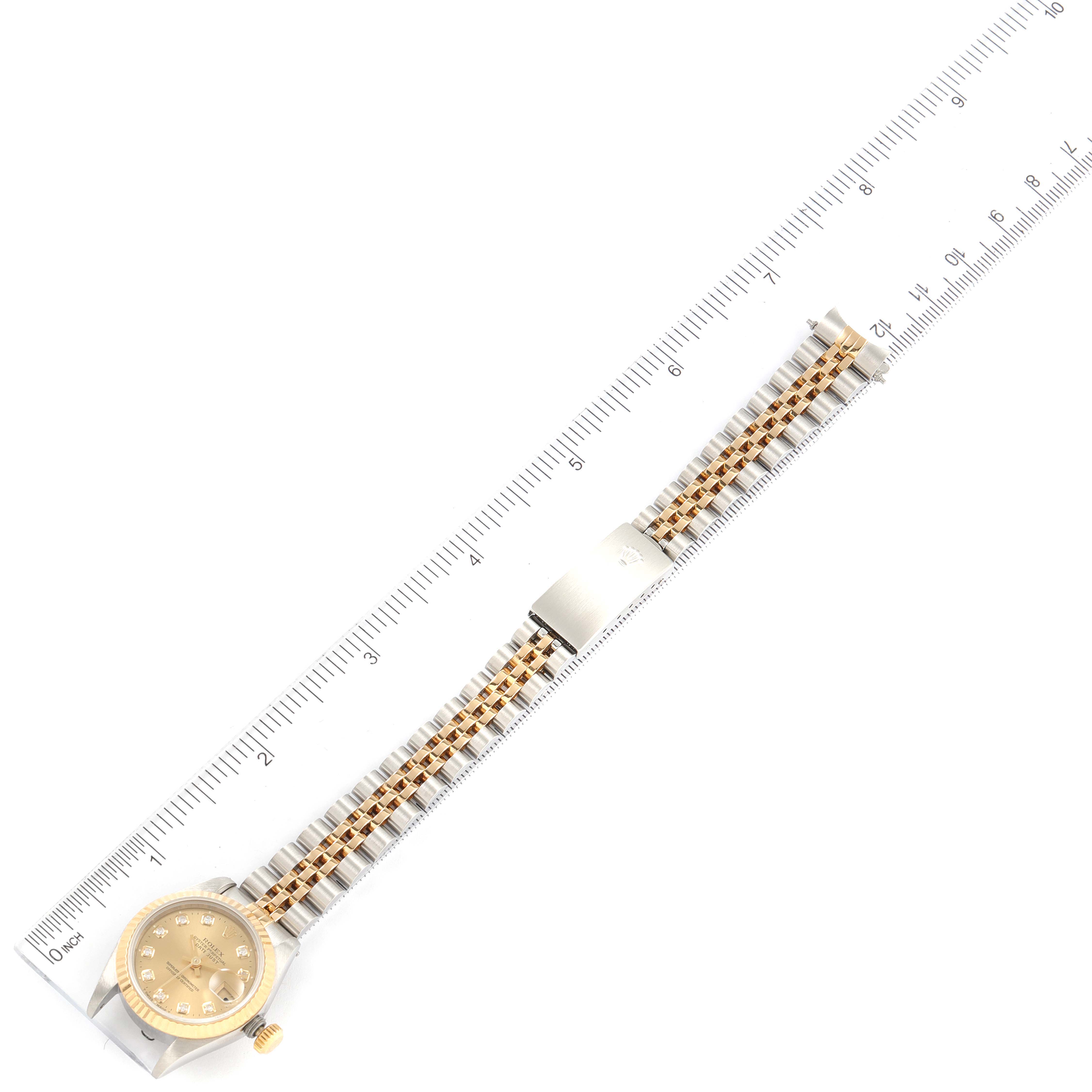 The image shows an overhead view of a Rolex Datejust 69173 Men's Steel and Gold (two tone) Champagne Dial 69173 Men's Steel and Gold (two tone) Champagne Dial watch with its face, bracelet, and clasp visible, alongside a ruler for scale.