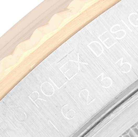 This image shows a close-up of the edge of a Rolex Datejust 16233 Men's Steel and Gold (two tone) Blue Dial 16233 Men's Steel and Gold (two tone) Blue Dial watch, highlighting the engraved model number and fluted bezel.