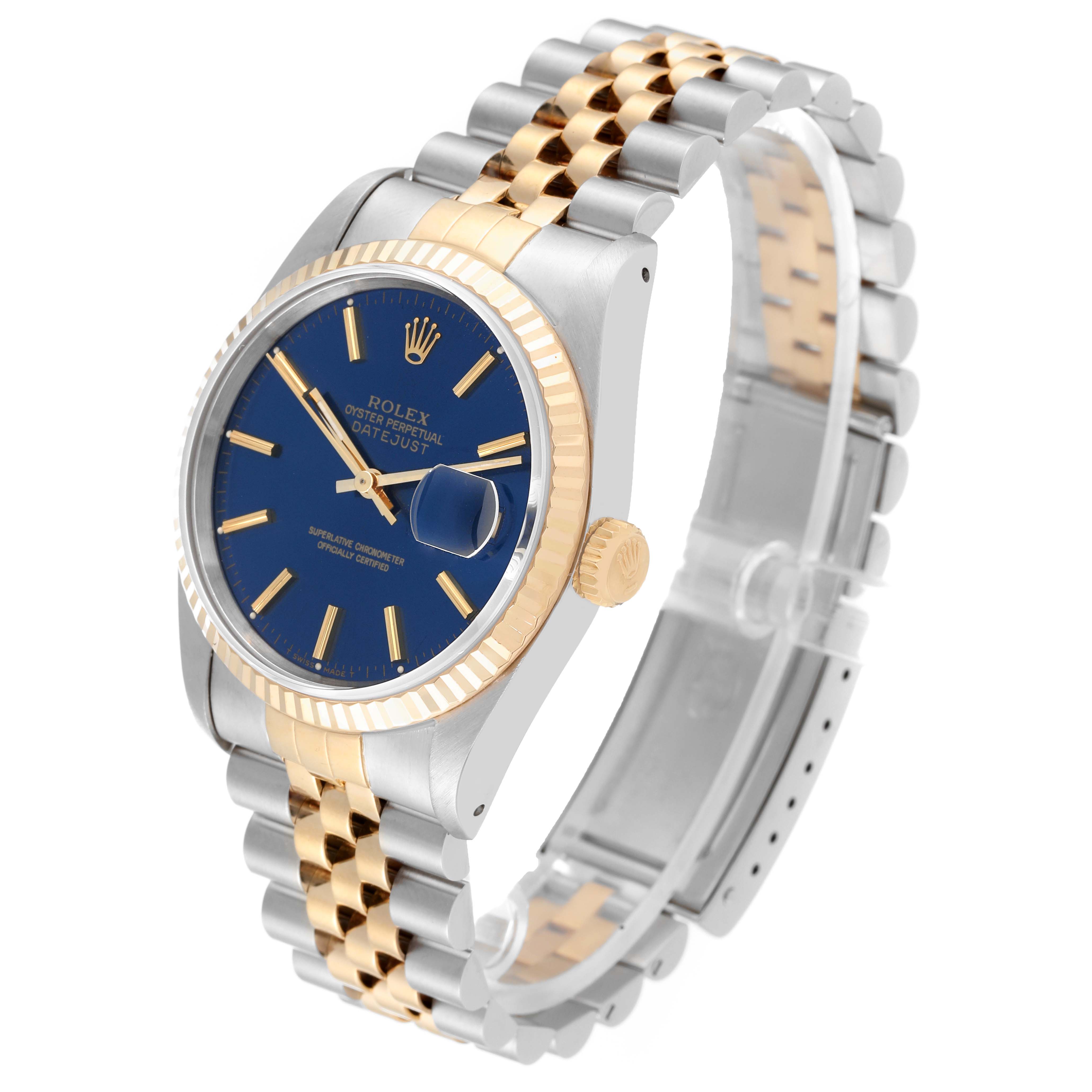 The Rolex Datejust 16233 Men's Steel and Gold (two tone) Blue Dial 16233 Men's Steel and Gold (two tone) Blue Dial model is shown from an oblique angle, highlighting its blue dial, jubilee bracelet, and fluted bezel.