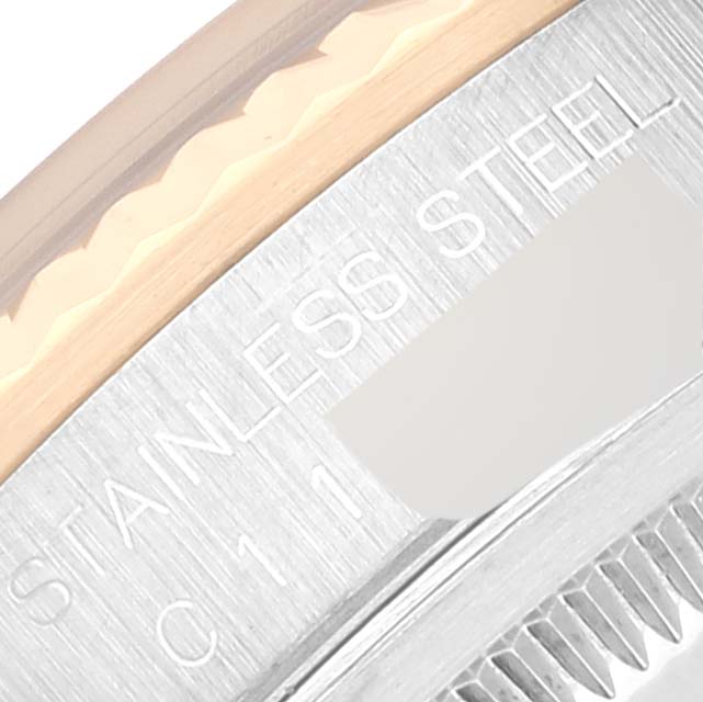 This close-up image of the Rolex Datejust 16233 Men's Steel and Gold (two tone) Blue Dial 16233 Men's Steel and Gold (two tone) Blue Dial watch shows part of the bezel, case, and engraved text.