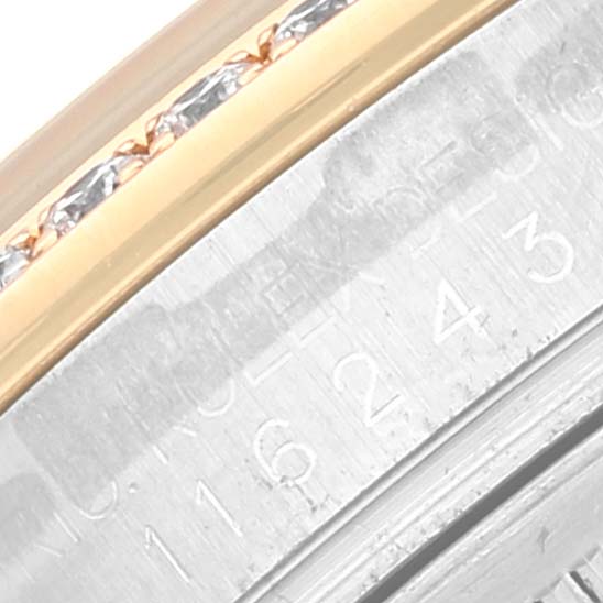 The image shows a close-up of the serial number engraving and the two-tone bezel of a Rolex Datejust 116243 Men's Steel and Gold (two tone) Silver Dial 116243 Men's Steel and Gold (two tone) Silver Dial watch.