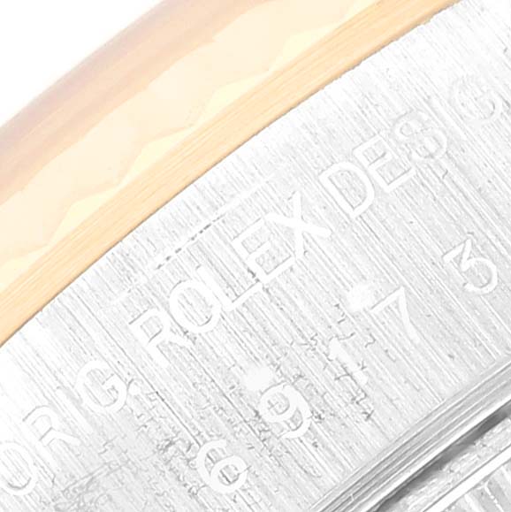 This close-up image shows the engraved details on the bezel of a Rolex Datejust 69173 Women's Steel and Gold (two tone) White Dial 69173 Women's Steel and Gold (two tone) White Dial watch.