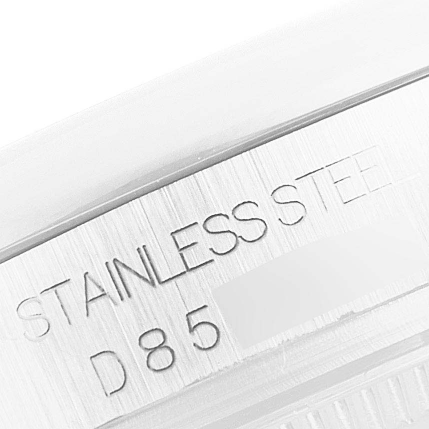 This image shows a close-up of the case back of a Mid-Size Rolex watch, highlighting the "Stainless Steel" engraving.