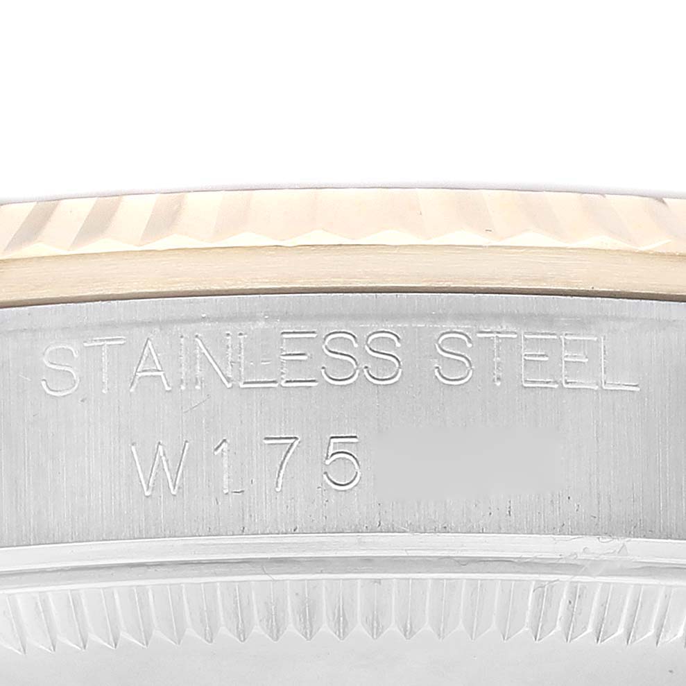 This is a close-up of the side of a Rolex Mid-Size 68273G Women
s Steel and Gold (two tone) Champagne Dial 68273G Women
s Steel and Gold (two tone) Champagne Dial model watch case, showing the engraving "STAINLESS STEEL W175."
