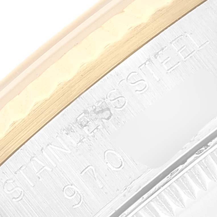 This image shows a close-up of the bezel edge and case markings indicating "Stainless Steel" on a Mid-Size Rolex watch.