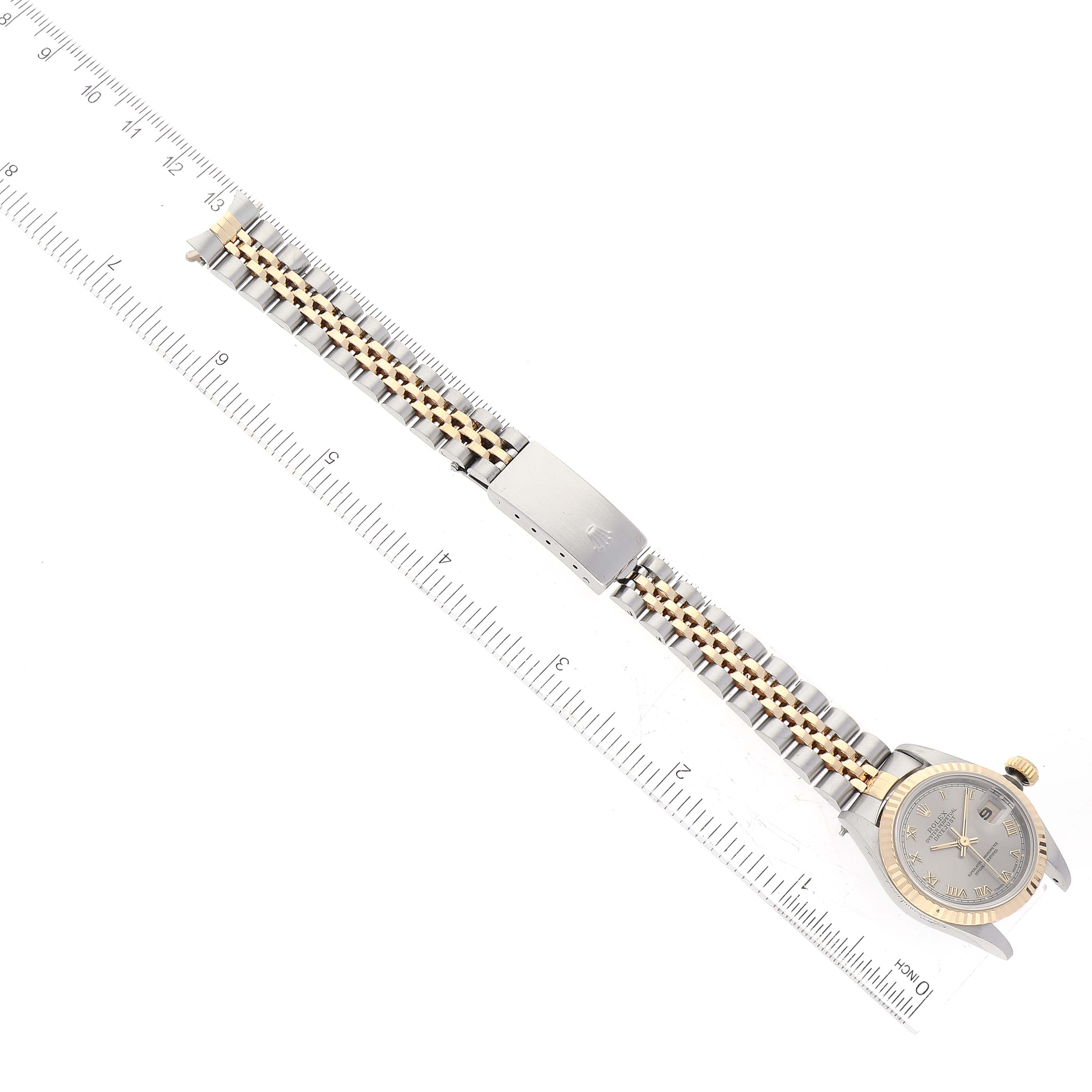 The image shows a Rolex Datejust 69173 Women's Steel and Gold (two tone) Grey Dial 69173 Women's Steel and Gold (two tone) Grey Dial watch laid flat, displaying its face, bracelet, and clasp, next to a ruler for measurement.