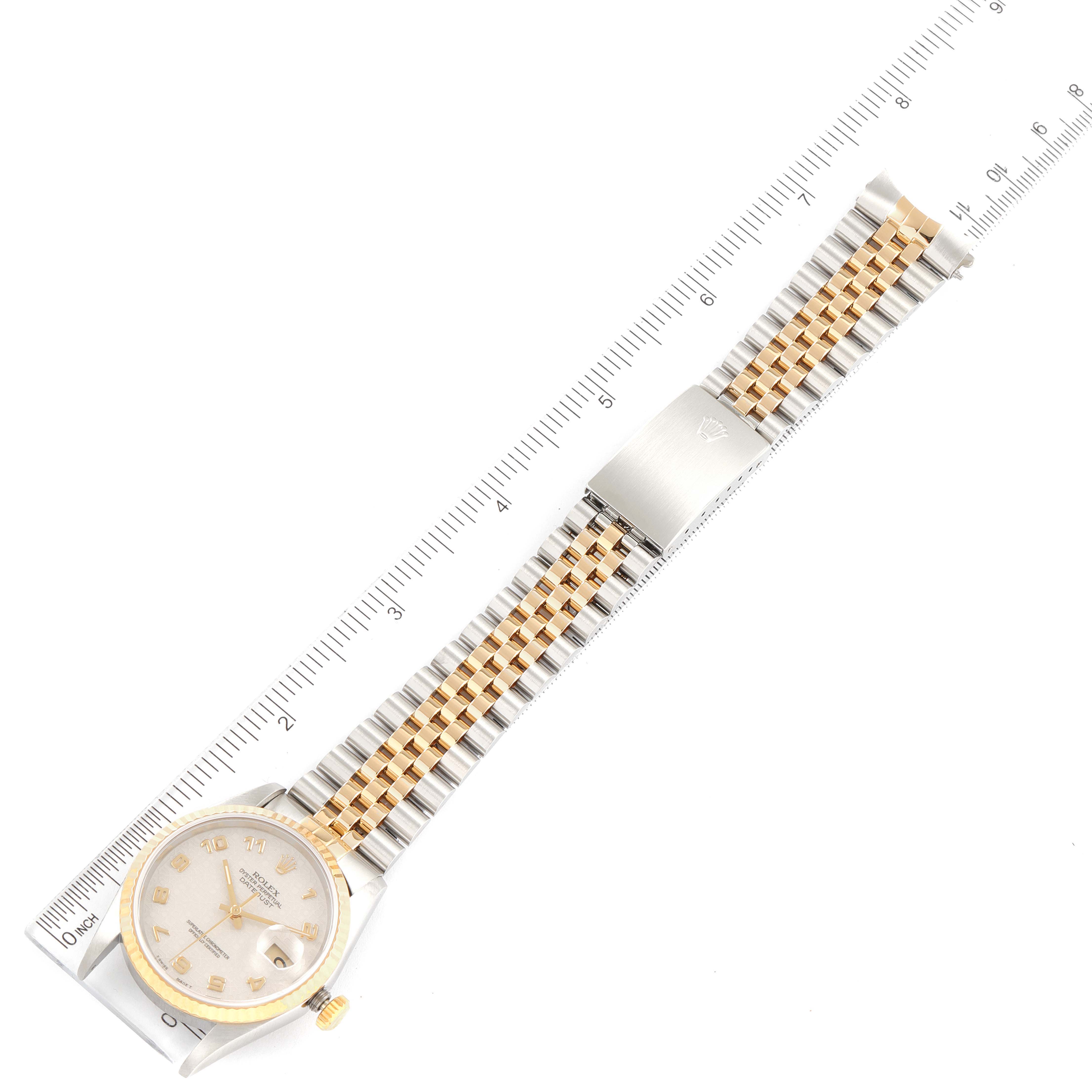 The image shows a top view of the Rolex Datejust 16233 Men
s Steel and Gold (two tone) Beige Dial 16233 Men
s Steel and Gold (two tone) Beige Dial watch, showcasing the face, bracelet, and clasp, aligned with a ruler for scale.