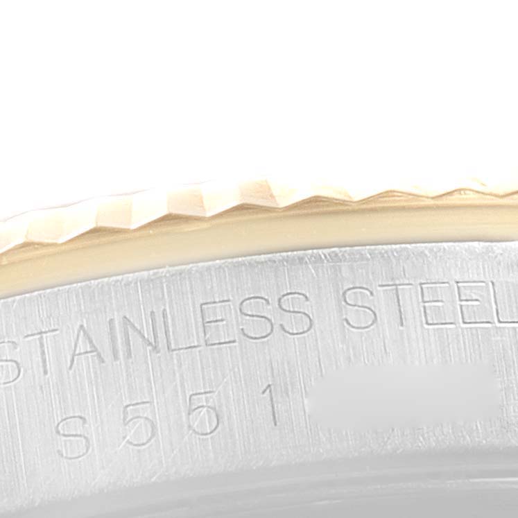 This close-up image of a Rolex Datejust 16233 Men
s Steel and Gold (two tone) Beige Dial 16233 Men
s Steel and Gold (two tone) Beige Dial watch shows part of the bezel and the engraved text on the stainless steel casing.