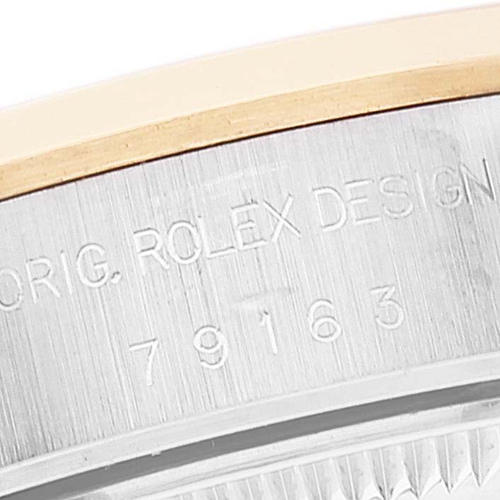 The image shows a close-up of the case back and engraving on a Rolex Datejust 79163 Women's Steel and Gold (two tone) White Dial 79163 Women's Steel and Gold (two tone) White Dial watch, displaying the model number and design details.