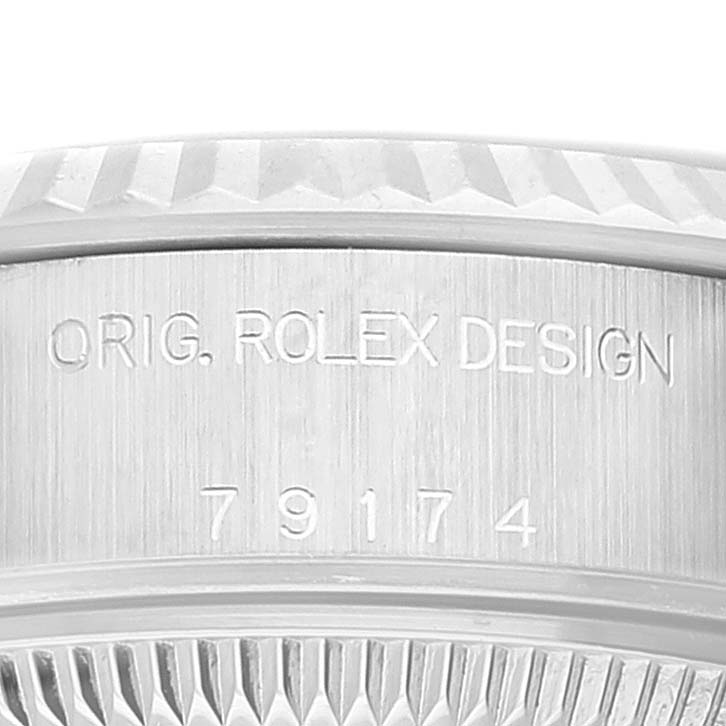 The image shows a close-up view of the case side of a Rolex Datejust 79174 Women's Stainless Steel Mother of Pearl Dial 79174 Women's Stainless Steel Mother of Pearl Dial watch, highlighting the bezel and engraved serial number.