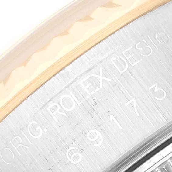 The image shows a close-up of the engraved side of a Rolex Datejust 69173 Women's Steel and Gold (two tone) Black Dial 69173 Women's Steel and Gold (two tone) Black Dial model watch.