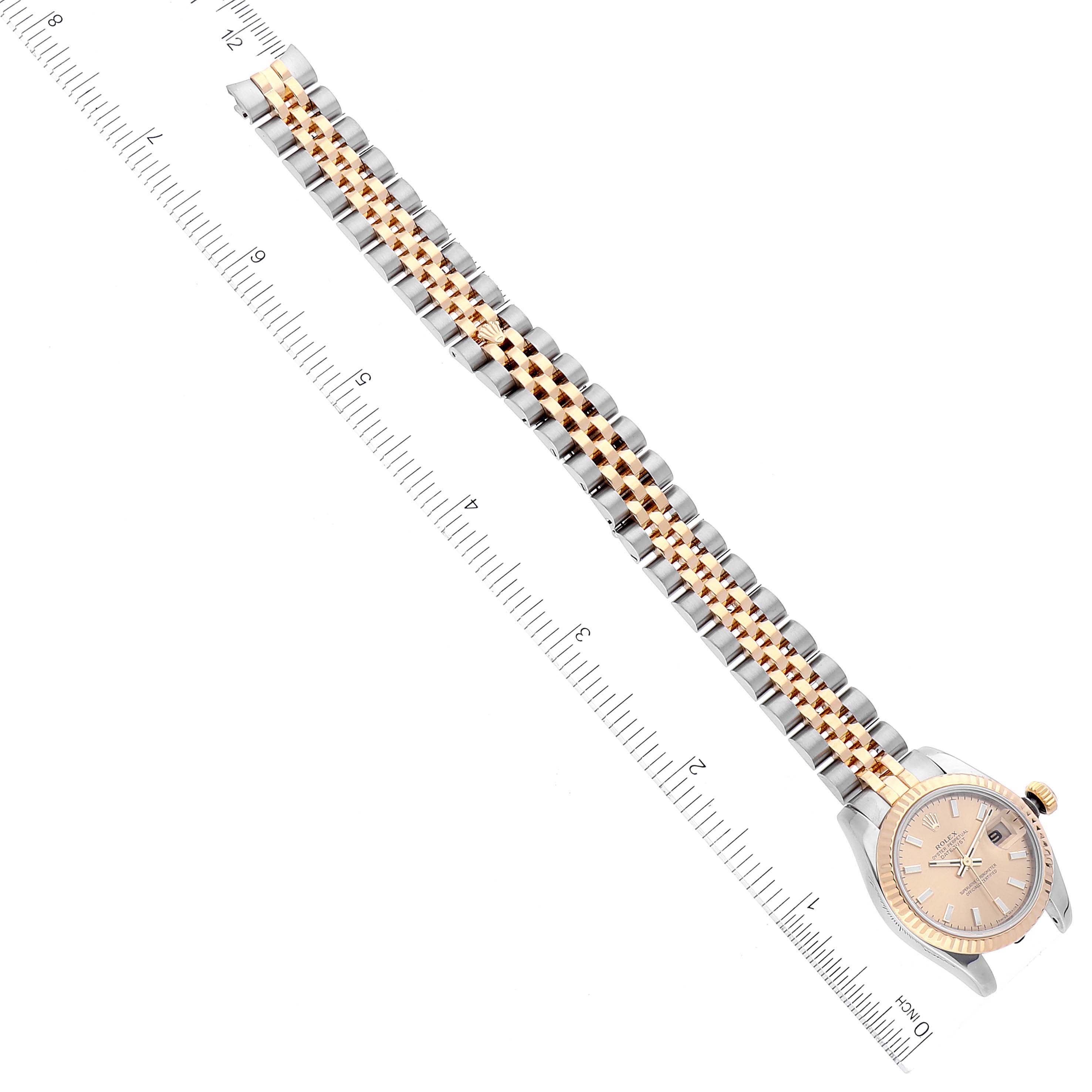 The image shows a Rolex Datejust 179173 Women's Steel and Gold (two tone) Champagne Dial 179173 Women's Steel and Gold (two tone) Champagne Dial watch with a gold and silver Jubilee bracelet, aligned next to a ruler for measurement.