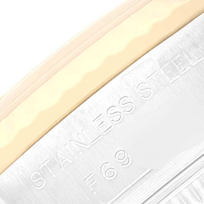 This close-up image shows the edge of the case and bezel of a Rolex Datejust 179173 Women's Steel and Gold (two tone) Champagne Dial 179173 Women's Steel and Gold (two tone) Champagne Dial watch, highlighting the "STAINLESS STEEL" engraving.