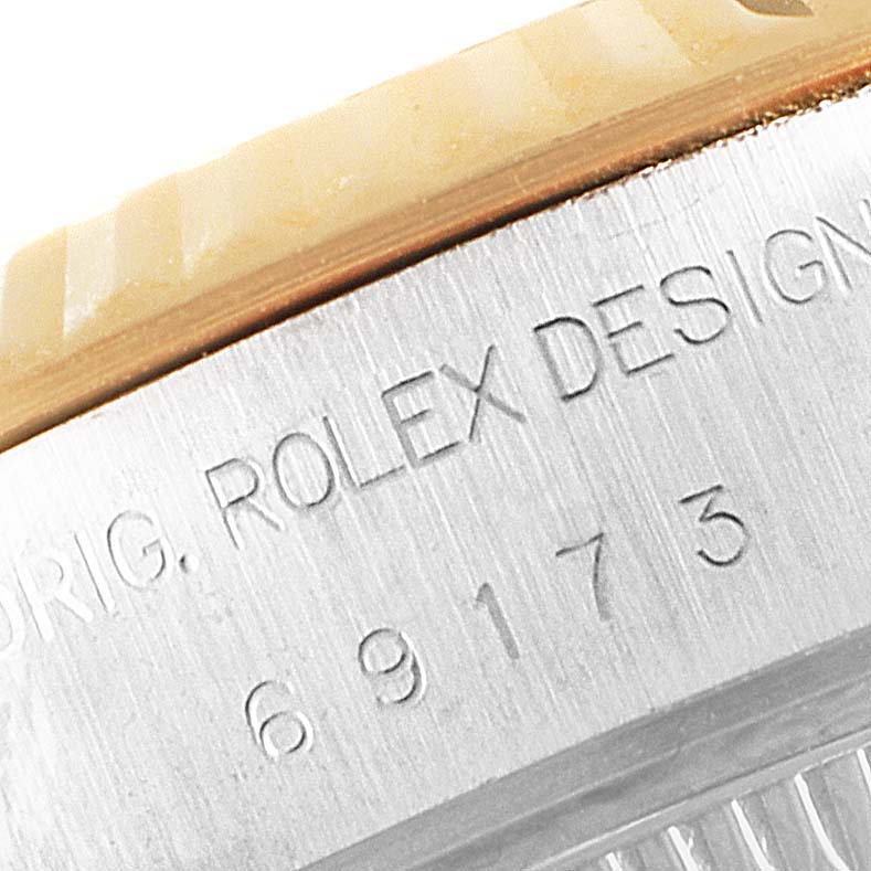 The image shows a close-up of the side engraving on a Rolex Datejust 69173 Women's Steel and Gold (two tone) Champagne Dial 69173 Women's Steel and Gold (two tone) Champagne Dial watch case.