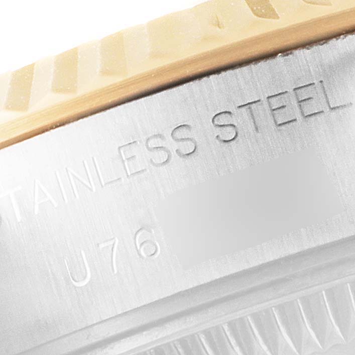 This close-up shows the engraved text on the side of the stainless steel case of a Rolex Datejust 69173 Women's Steel and Gold (two tone) Champagne Dial 69173 Women's Steel and Gold (two tone) Champagne Dial watch.