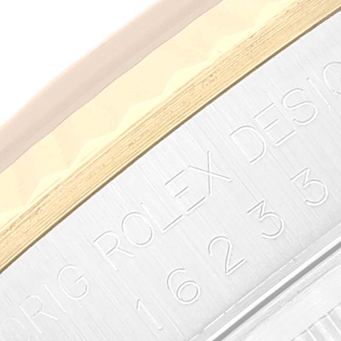 The image shows a close-up of the engraved side of a Rolex Datejust 16233 Men's Steel and Gold (two tone) Beige Dial 16233 Men's Steel and Gold (two tone) Beige Dial, highlighting its reference numbers and part of the bezel.